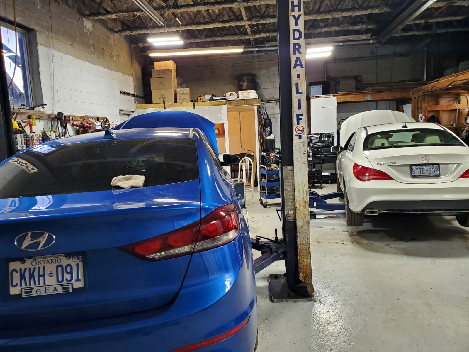 Inside The Car Doctor workshop with vehicles on lifts